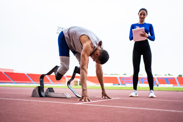 Asian athlete with prosthetic blades and trainer workout in stadium.