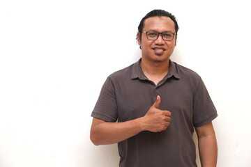 asian man giving thumbs up as a sign of approval or appreciation, isolated white background