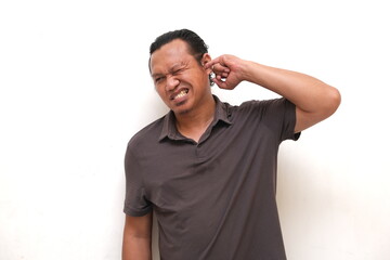 asian man picking ear with finger isolated white background