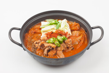 A stew made with kimchi, tofu, and pork