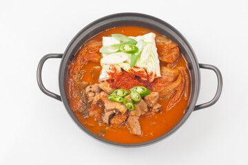 A stew made with kimchi, tofu, and pork