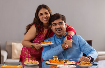 Sibling celebrating Raksha Bandhan festival at home