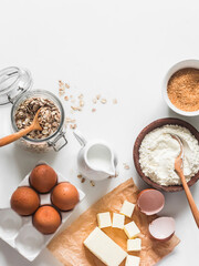Ingredients baking background - oat flakes, flour, cane sugar, butter, eggs on a light background, top view