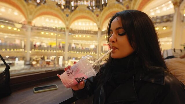 Attractive Female Tourist Inside The Elegant Shopping Center Of Galeries Lafayette Haussmann In Paris, France. Close Up