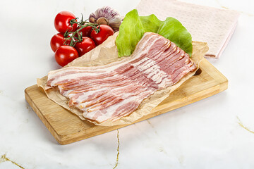 Sliced pork bacon oved board