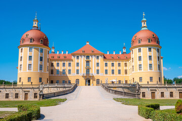 Fototapeta premium Moritzburg, Saxony, Germany - July 7, 2023: Famous ancient Moritzburg Castle, main entrance, near Dresden at sunny summer day with blue sky