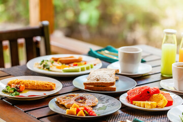 Morning food breakfast at tropical hotel in Thailand. Variety of dishes, including sandwiches,...