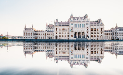 Fototapeta na wymiar Parliament building in Budapest with fantastic perfect sky and reflection in water. calm Danube river. Popular Travel destinations.