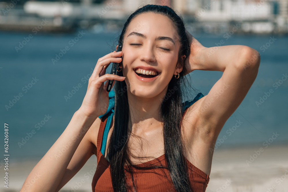 Wall mural happy young woman with mobile phone