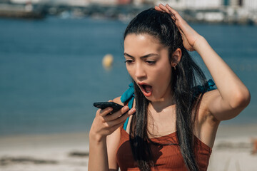 angry young woman sending a voice message on the phone - Powered by Adobe