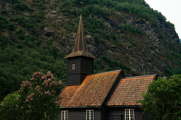 Fototapeta na wymiar Steeple of the beautiful black wooden stave church (kyrkje) in Flåm, Norway
