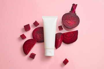 Scene for advertising and branding cosmetic with beetroot ingredient. An empty white plastic tube...