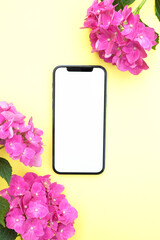 Blank phone screen mockup for digital invitation, design, 
presentation, flat lay with pink  hydrangea flowers, smartphone template for electronic card. . Top view, copy space for text, product place.