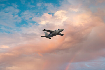 Fototapeta na wymiar Military aircraft in flight at sunset
