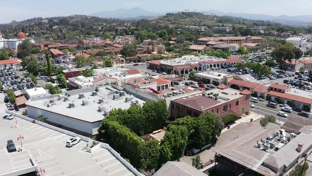 Low descending aerial shot of the Franciscan Gardens wedding venue with the Mission in the background in San Juan Capistrano, California. 4K