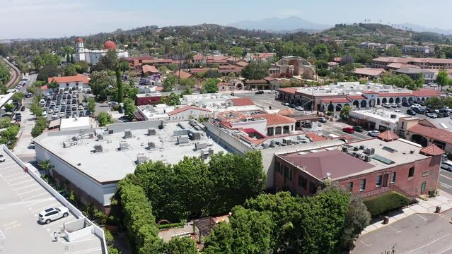 Aerial rising and panning shot of the Franciscan Gardens wedding venue with the Mission San Juan Capistrano in the background in California. 4K