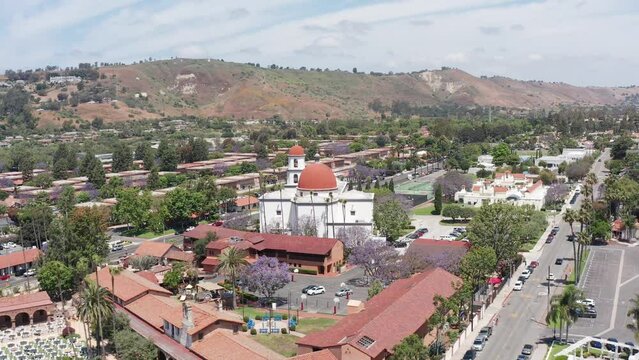 Aerial wide rising shot of the Mission Basilica in San Juan Capistrano, California. 4K
