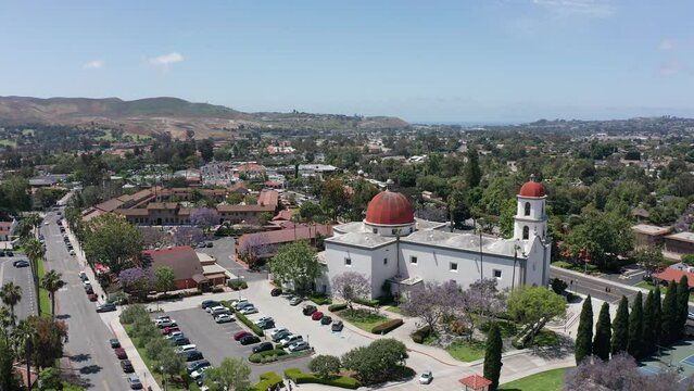 Aerial wide panning shot of the Mission Basilica with the Mission San Juan Capistrano in the background in California. 4K