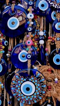 A lot of key rings and pendants, bracelets with a blue eye, amulets, beads from the evil eye in the souvenir shop of the Turkish city