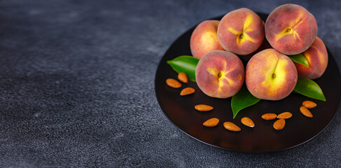 Harvest of peaches for food or juice. fresh organic fruit, vegan food. Large peaches on dark table background, selective focus.