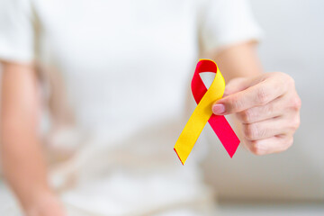 woman holding Red and Yellow ribbon. World hepatitis day awareness month, 28 July, Liver cancer, Jaundice, Cirrhosis, Failure, Enlarged, Hepatic Encephalopathy and Health concept