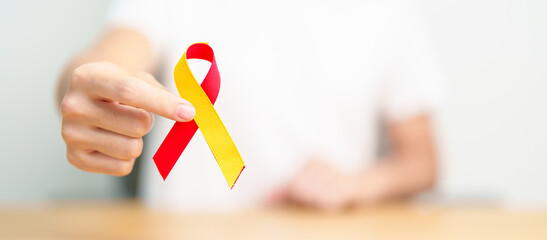 woman holding Red and Yellow ribbon. World hepatitis day awareness month, 28 July, Liver cancer, Jaundice, Cirrhosis, Failure, Enlarged, Hepatic Encephalopathy and Health concept
