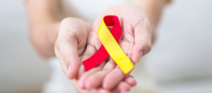 woman holding Red and Yellow ribbon. World hepatitis day awareness month, 28 July, Liver cancer, Jaundice, Cirrhosis, Failure, Enlarged, Hepatic Encephalopathy and Health concept