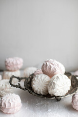 white and pink zephyr on a white background. zephyr in a vintage bowl close-up.	