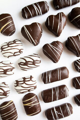 cookies in chocolate close-up. candies in chocolate glaze. sweets in white and black chocolate.