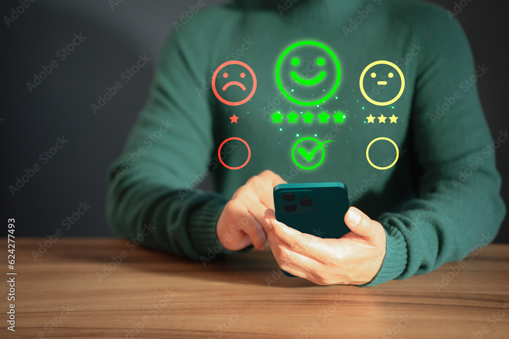 Aufkleber client hands using a mobile phone with pop up smile face icon for feedback review satisfaction servi