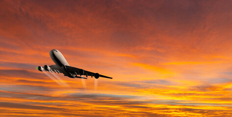 Fototapeta na wymiar Passenger commercial aircraft flying above the clouds in sunset light.