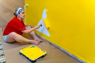 Yellow Wall Makeover: Middle-Aged Woman Enhancing Her Living Space