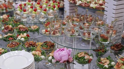 Buffet and snacks at a business event. Catering serves a banquet, beautiful and neat snacks are laid out on trays for guests.