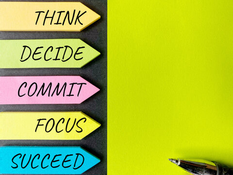 Inspirational and Motivational Concept - THINK DECIDE COMMIT FOCUS SUCCEED text on multicolor notepaper background. With copy space.