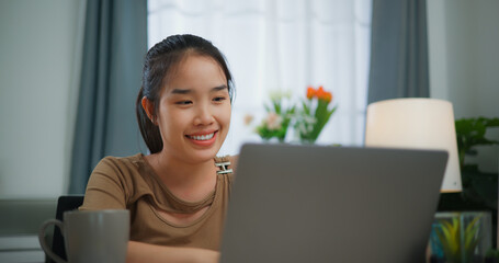 Young Asian woman working with a laptop on a desk