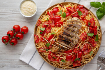 Homemade Bruschetta Chicken Pasta on a Plate, top view. Flat lay, overhead, from above.