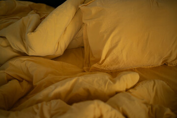 Fototapeta na wymiar Morning in bed. The bedding is orange
