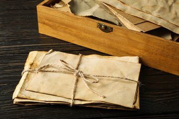 Box and old letters on wooden background