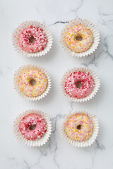 Glazed donuts on marble background, top view