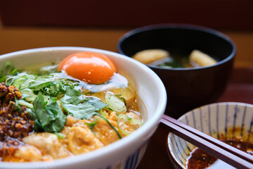 Oyakodon set, bowl of rice topped with chicken and eggs, and miso soup with kitsune tofu and wakame...