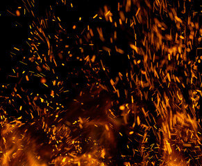Fototapeta na wymiar fire flame with sparks on black background.