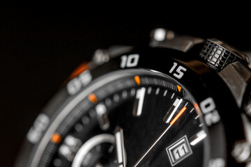 Closeup of man watch on a black background. Wrist clock. Concept image concerning time and planning activity.