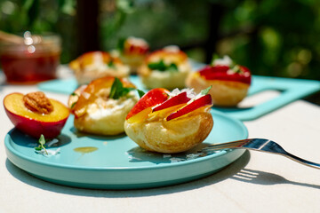 Mini sandwiches with cream cheese, nectarines, coconut, mint and honey. Delicious summer peaches toast, healthy lunch idea.