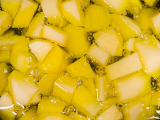 Close up of potatoes being fried in hot olive oil. Cooking, recipes concept.