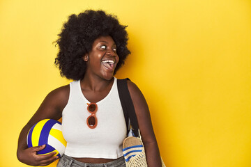 Beach-ready woman with volleyball, ready for sport points with thumb finger away, laughing and...
