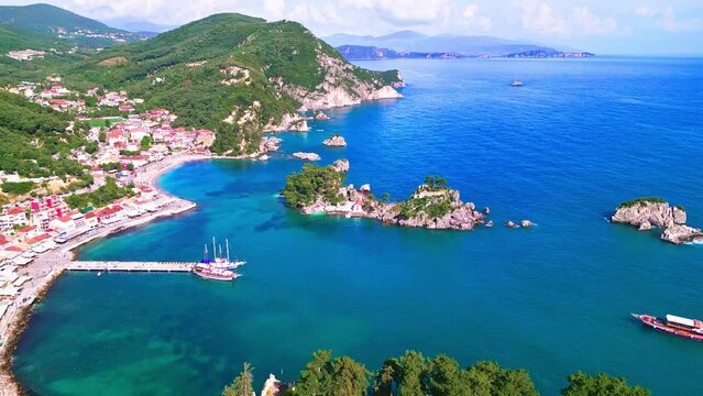 Parga, Greece. Aerial view of picturesque coastal town, stunning beaches, turquoise waters, historical charm, and a vibrant summer atmosphere.