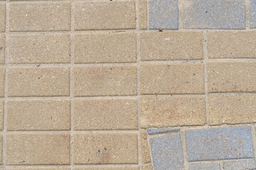 Texture tiles on the street, warm shade, top view, close-up.