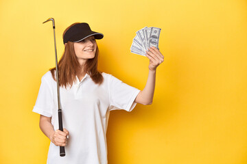 Redhead golfer with club and dollars, winning in sports concept.