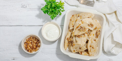 Dumplings, filled with cabbage. Fried onion, fresh sour cream. Traditional Ukrainian dish
