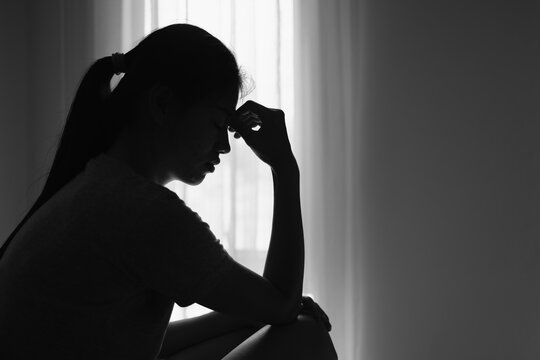 Silhouette of  woman who stressed severely, depression or domestic violence. The concept of sexual harassment against women and rape. human trafficking, international women's day.